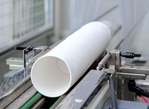 White paper cups on machine