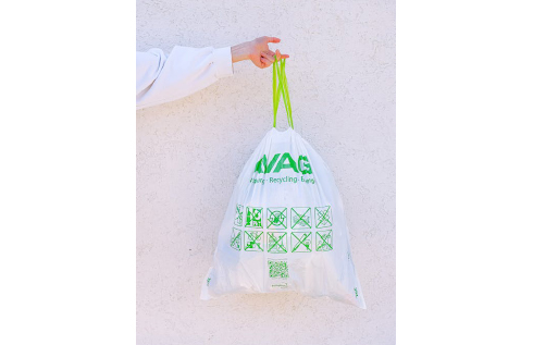 Person Holding White and Green Plastic Bag