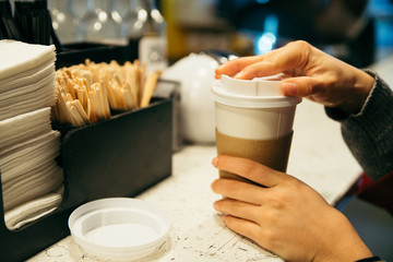 Person holding coffee paper cup
