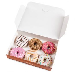assorted donuts with different fillings in the box isolated on white background
